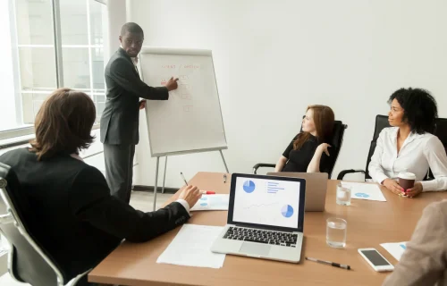 african-american-businessman-giving-presentation-explaining-new-marketing-plan-meeting